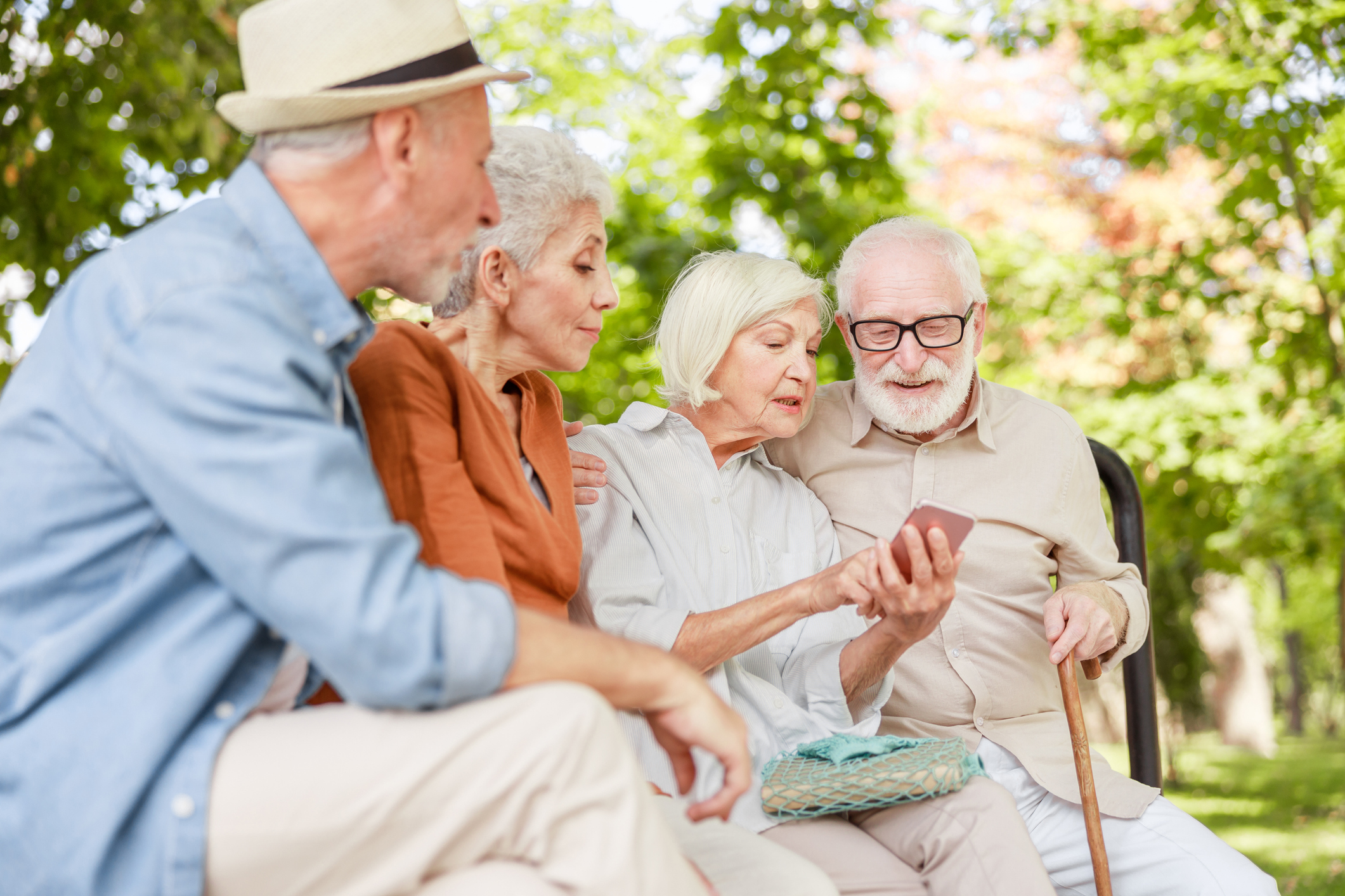 Group of old people watching video on smartphone stock photo